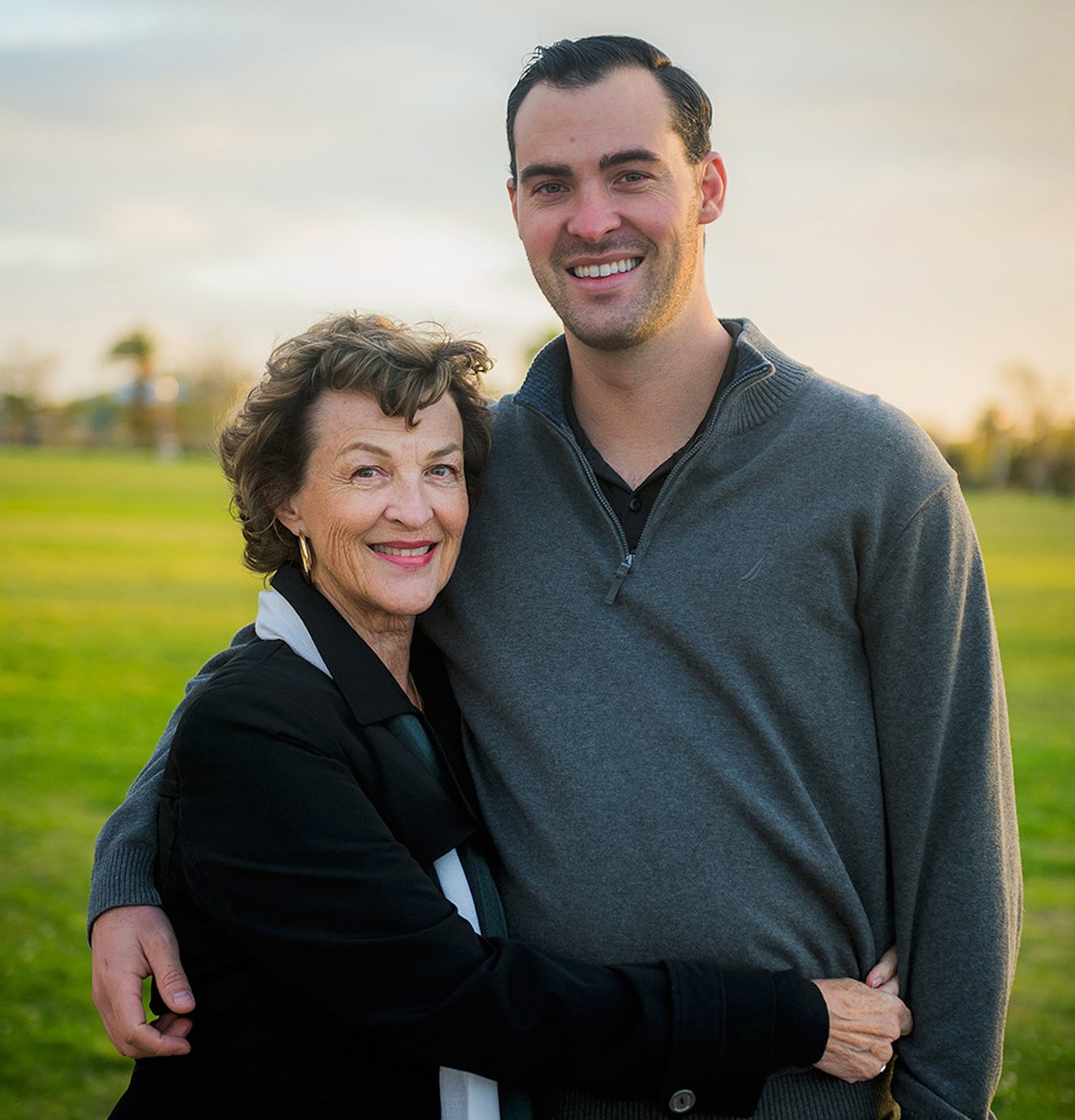 Ryan and his mother standing in a field